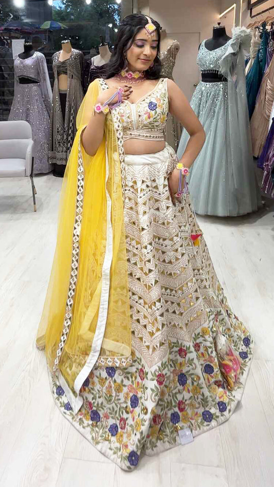 Cream lehenga choli in raw silk with multicolor thread & leather work and contrasting yellow dupatta