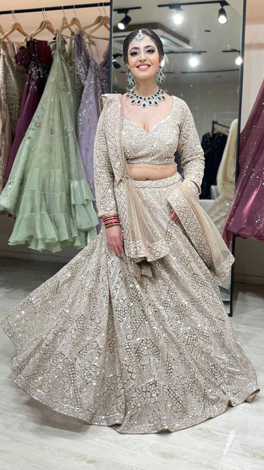 Nude color net bridal lehenga with zarkan & sequins along with heavy dupatta