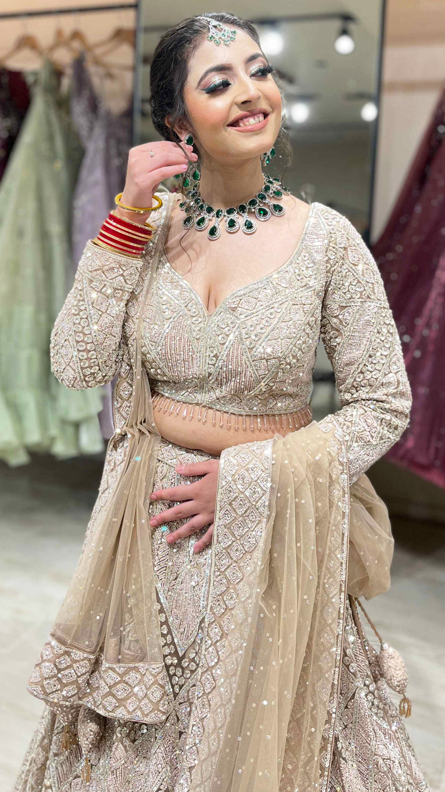 Nude color net bridal lehenga with zarkan & sequins along with heavy dupatta