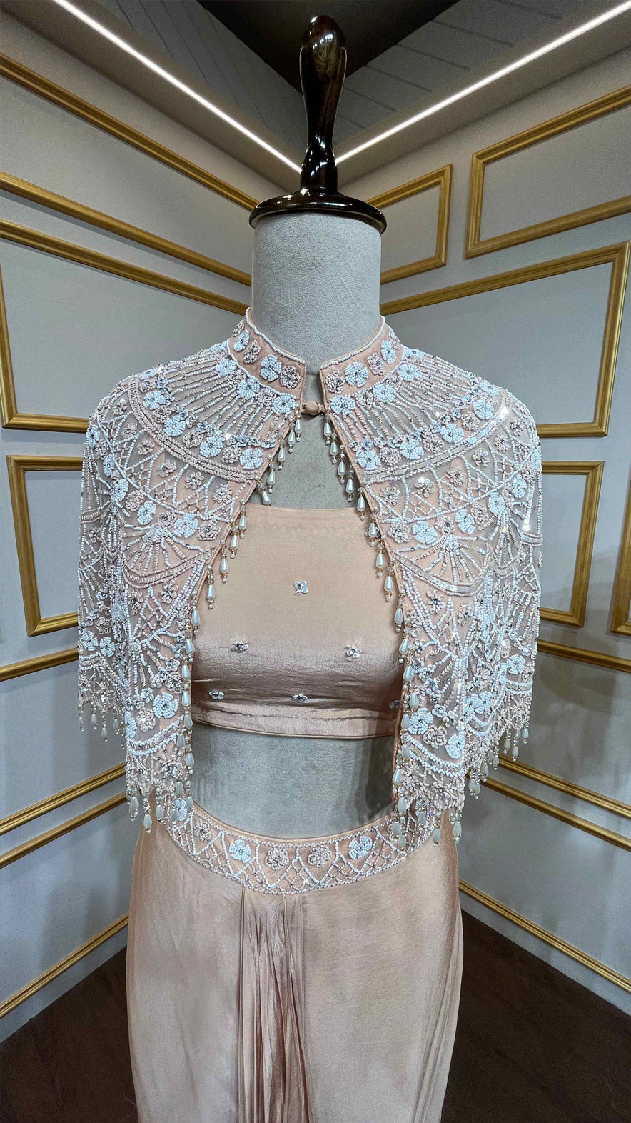 Powder peach dhoti style in crape with net poncho with pearl & tube work
