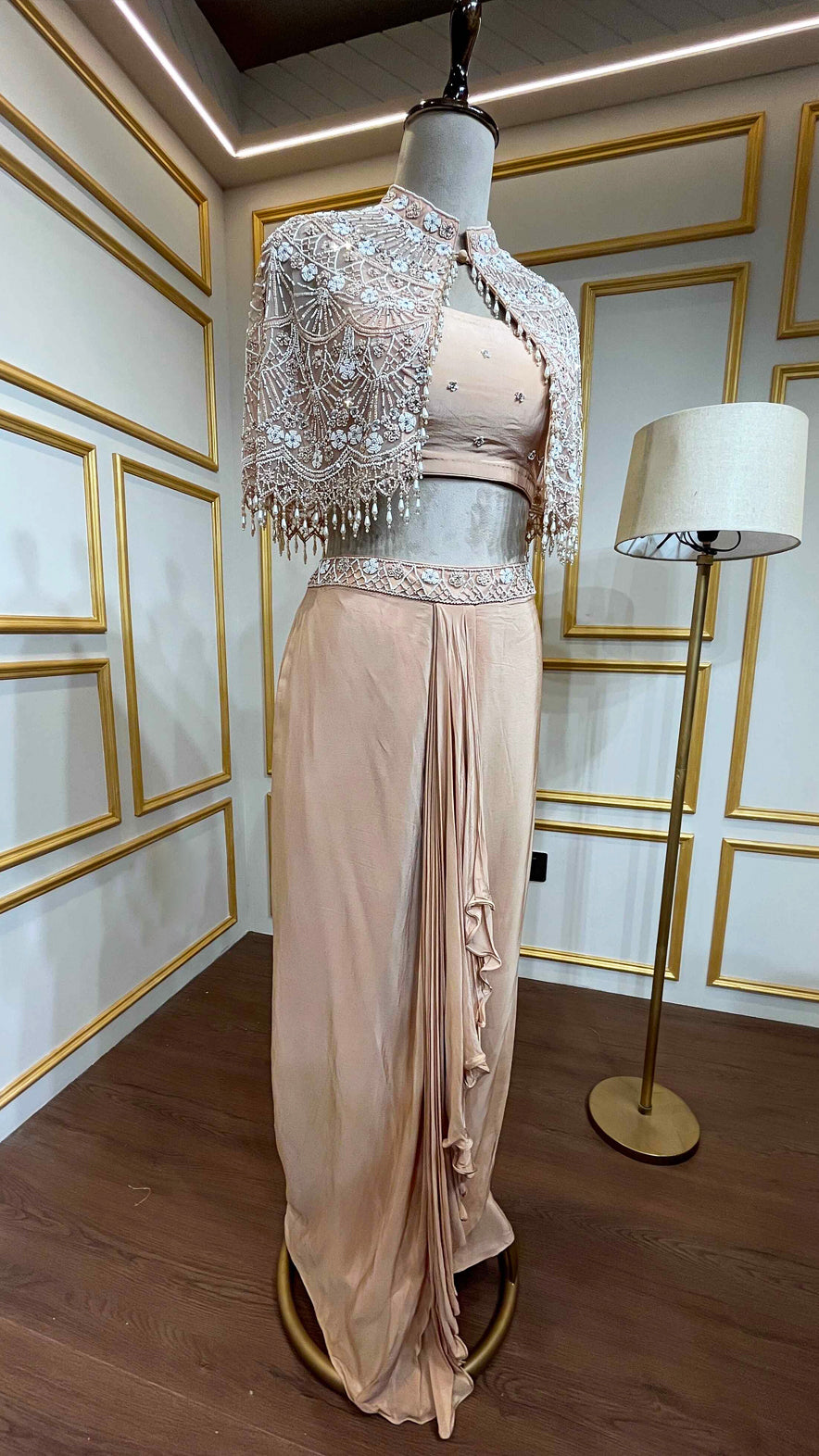Powder peach dhoti style in crape with net poncho with pearl & tube work
