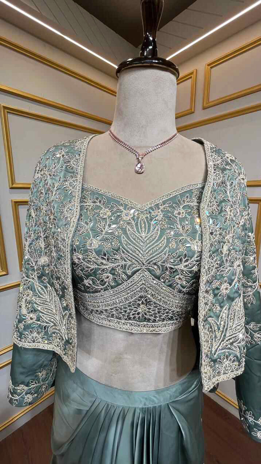 Satin dhoti skirt with thread & crystal work crop top and jacket in pine green