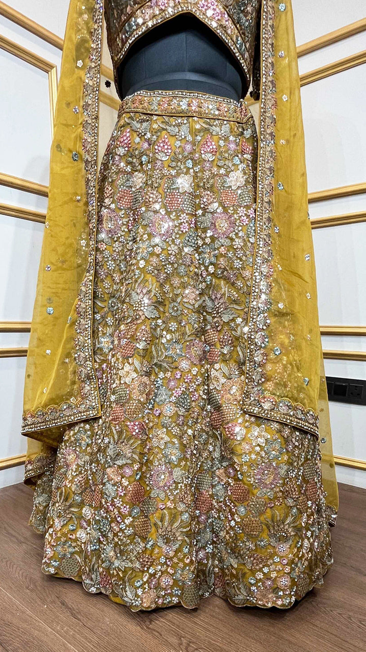 Thread & pearl work on dusty mustard lehenga in organza with heavy dupatta