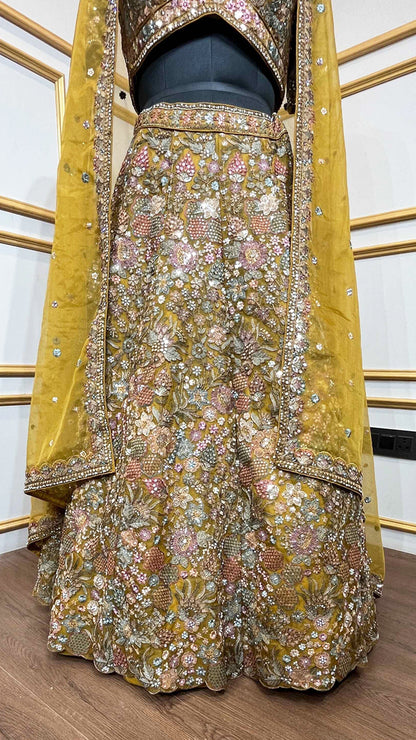 Thread & pearl work on dusty mustard lehenga in organza with heavy dupatta