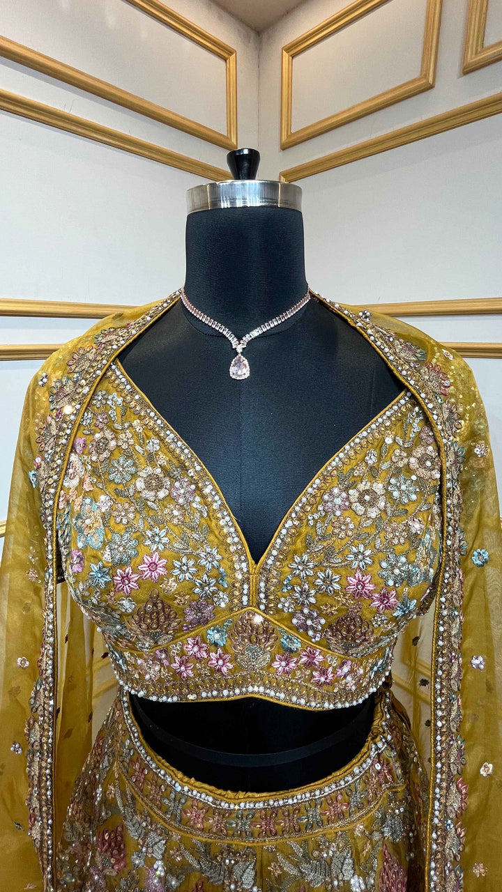 Thread & pearl work on dusty mustard lehenga in organza with heavy dupatta