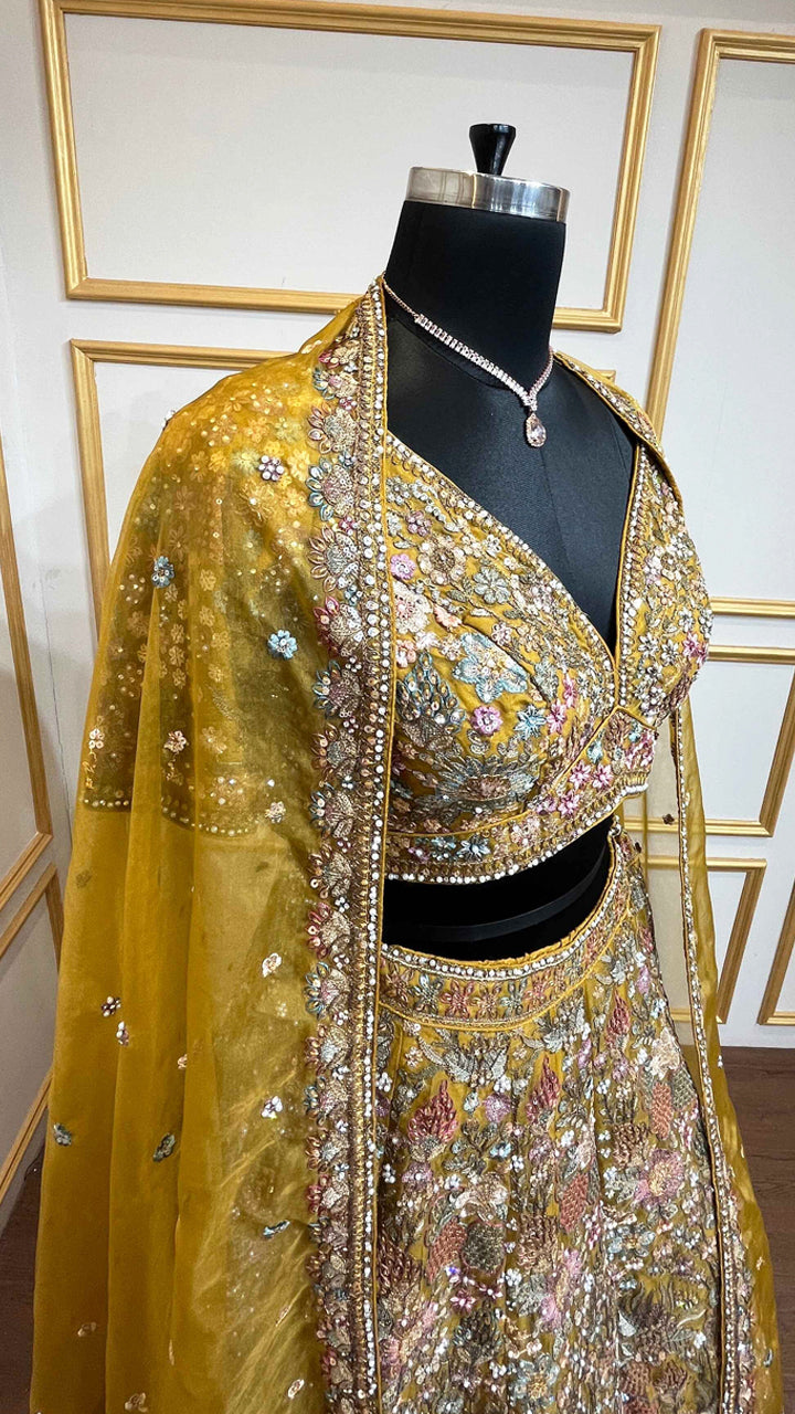 Thread & pearl work on dusty mustard lehenga in organza with heavy dupatta