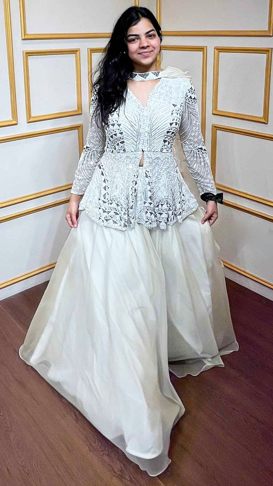 Ivory peplum top with pearl & zarkan work in net along with organza skirt