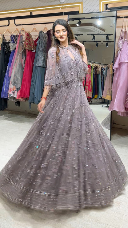 Soft Mauve engagement gown with pearl & Crystal work on net along with a cape