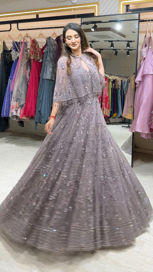 Soft Mauve engagement gown with pearl & Crystal work on net along with a cape