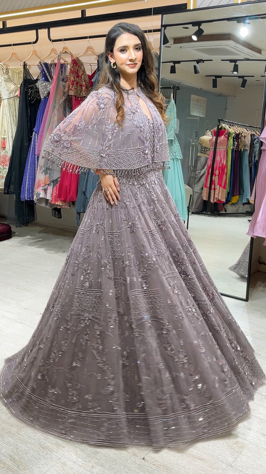Soft Mauve engagement gown with pearl & Crystal work on net along with a cape