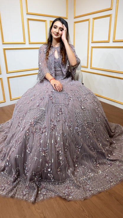 Soft Mauve engagement gown with pearl & Crystal work on net along with a cape