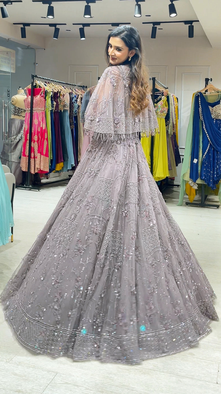 Soft Mauve engagement gown with pearl & Crystal work on net along with a cape
