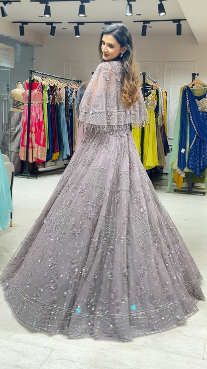 Soft Mauve engagement gown with pearl & Crystal work on net along with a cape