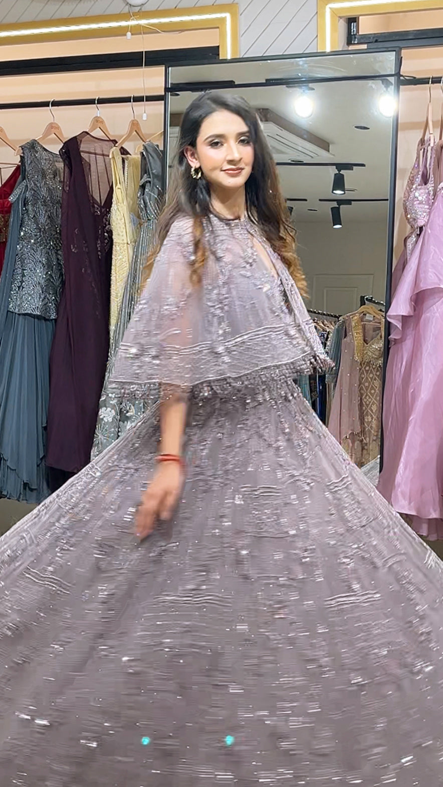 Soft Mauve engagement gown with pearl & Crystal work on net along with a cape
