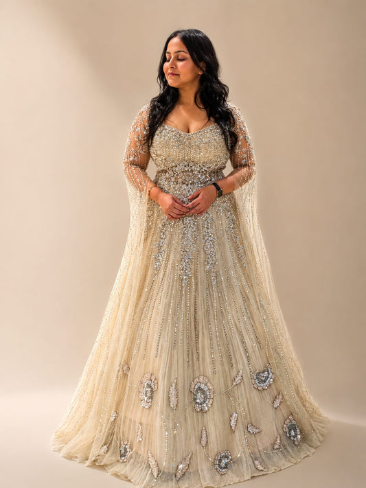 Ivory champagne net engagement gown with heavy embroidered falling sleeves with pearl & zarkan