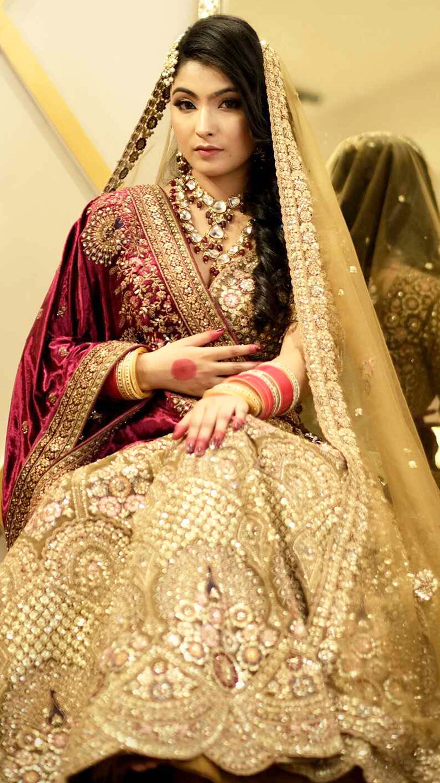 Zari & multicolor thread work on net bridal lehenga in tan with heavy dupattaZari & multicolor thread work on net bridal lehenga in tan with heavy dupatta