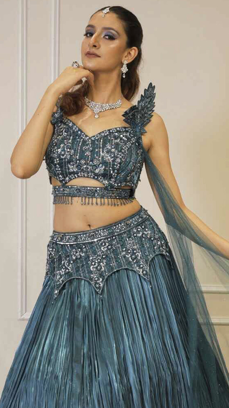 Dark teal lehenga with cutwork blouse on crystal & sequins work with falling sleeves