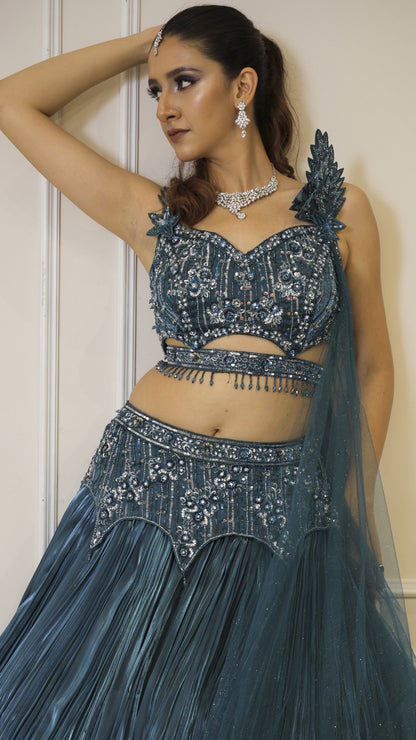 Dark teal lehenga with cutwork blouse on crystal & sequins work with falling sleeves