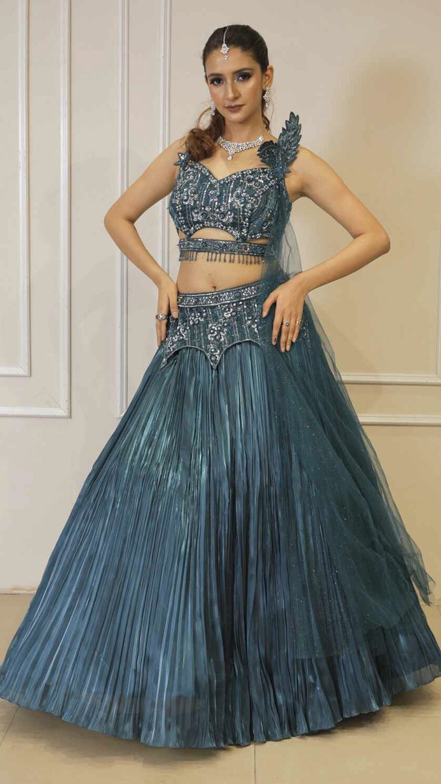 Dark teal lehenga with cutwork blouse on crystal & sequins work with falling sleeves