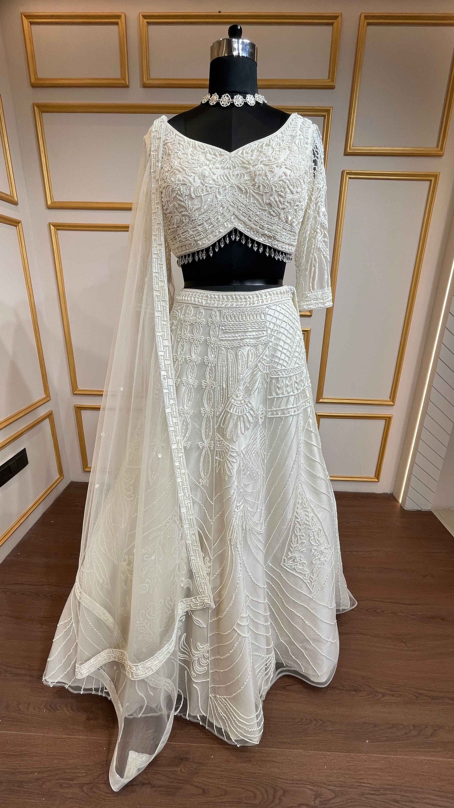 Ivory net lehenga with cut dana & sequins