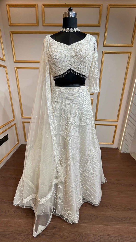 Ivory net lehenga with cut dana & sequins