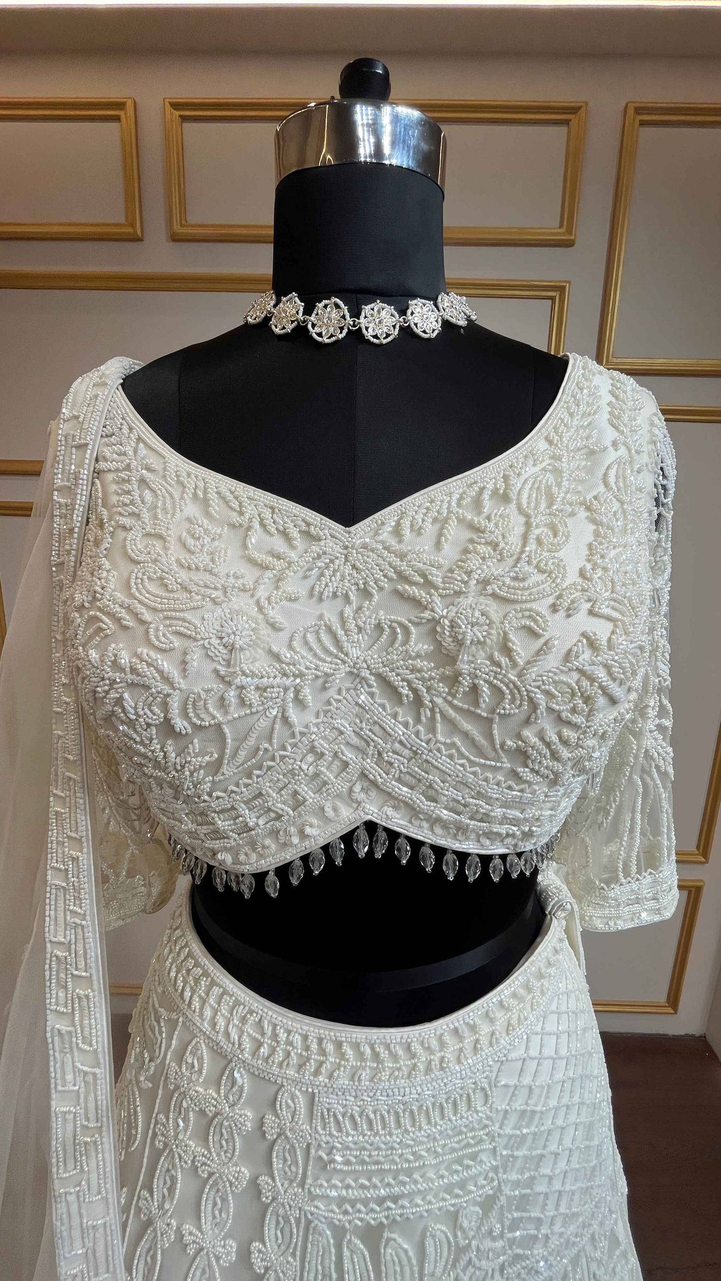 Ivory net lehenga with cut dana & sequins