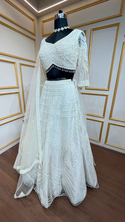 Ivory net lehenga with cut dana & sequins