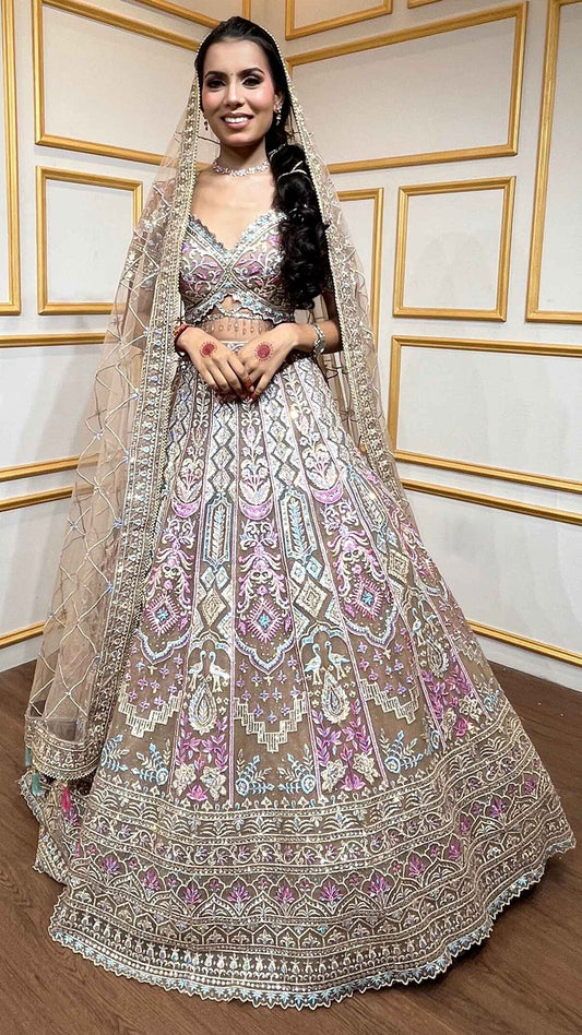 Multicolor thread & zari work on nude brown net lehenga with heavy dupatta