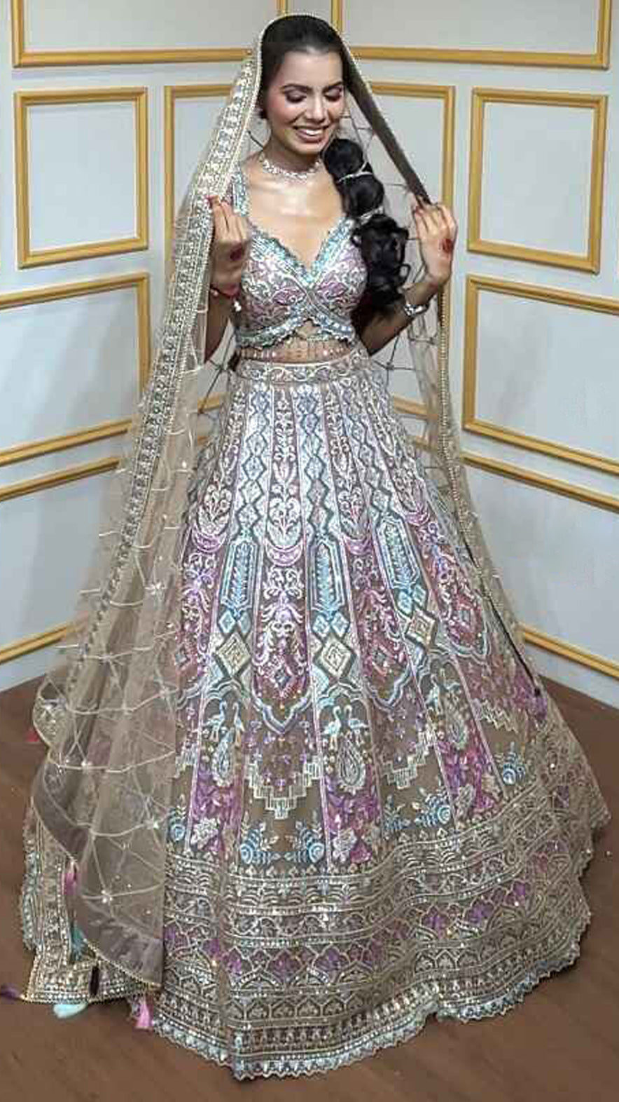 Multicolor thread & zari work on nude brown net lehenga with heavy dupatta