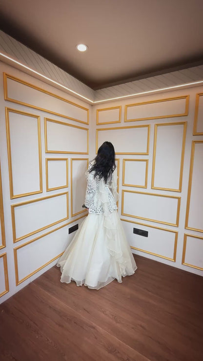 Ivory peplum top with pearl & zarkan work in net along with organza skirt