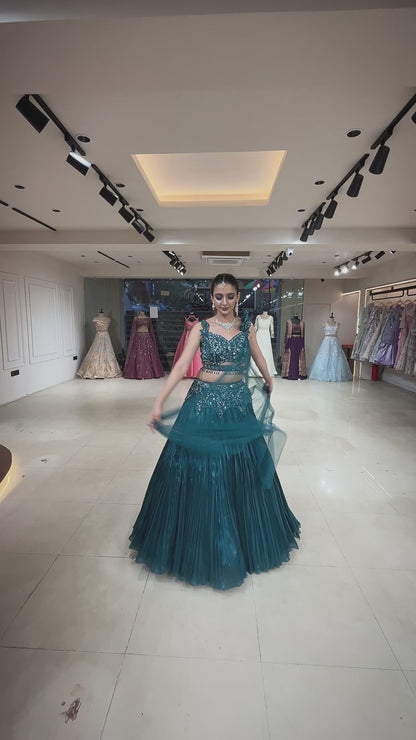 Dark teal lehenga with cutwork blouse on crystal & sequins work with falling sleeves
