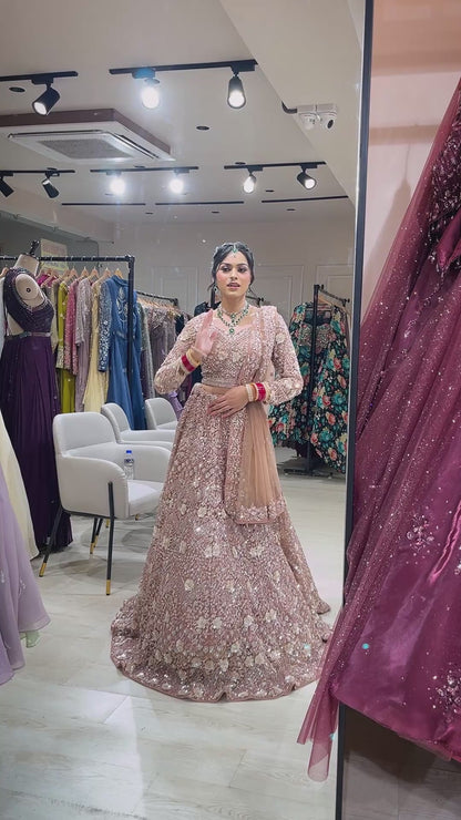 Dusty coral bridal lehenga in net with zarkan & swarovski along with four side border dupatta
