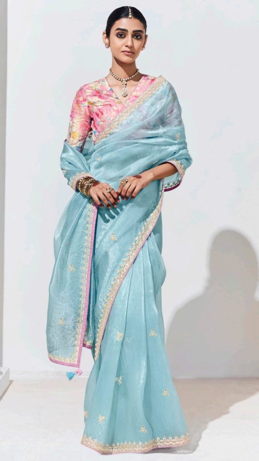 Baby blue organza saree with contrasting printed light pink unstitched blouse