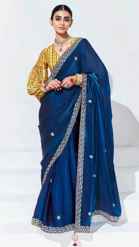 Sapphire blue saree with contrasting printed yellow unstitched blouse in glaze organza