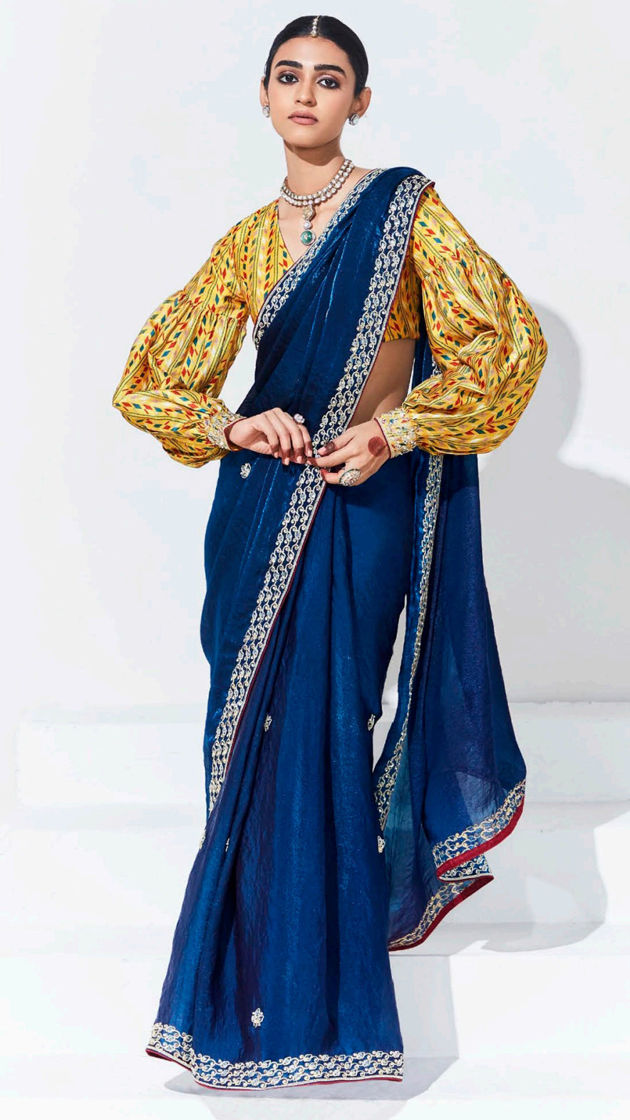 Sapphire blue saree with contrasting printed yellow unstitched blouse in glaze organza